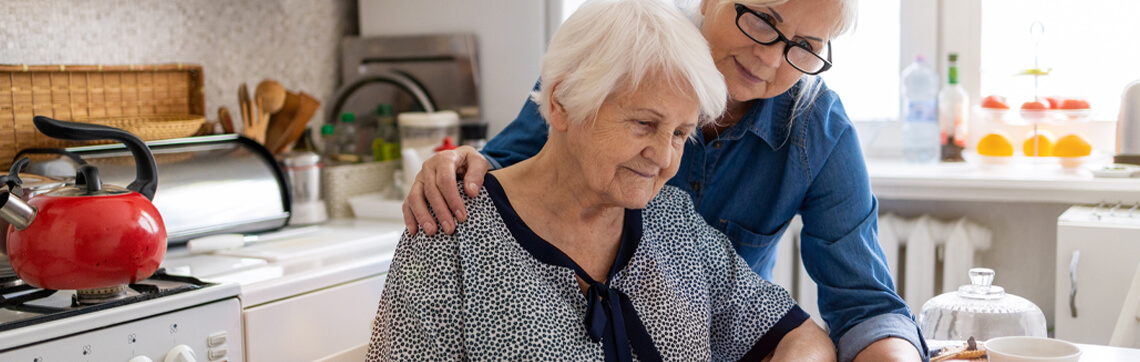 Woman helping elderly woman with finances