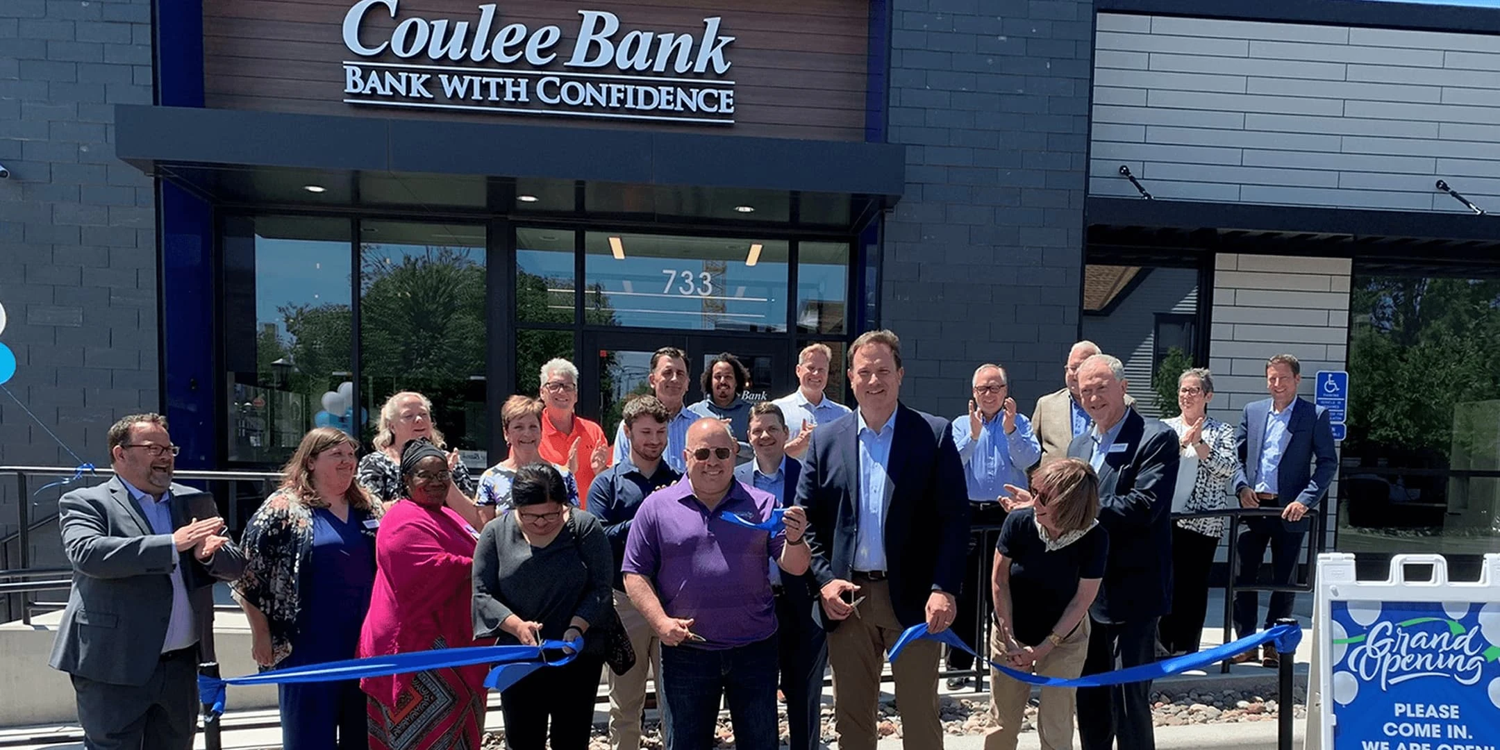 Cutting the ribbon in front of the St. Paul location