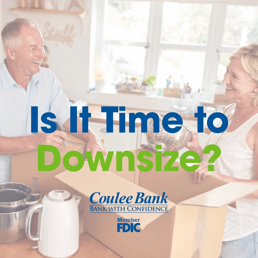 Smiling older couple packing kitchen items into boxes with text overlay: "Is It Time to Downsize?" and Coulee Bank logo.