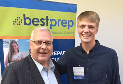 Two people standing in front of best prep sign